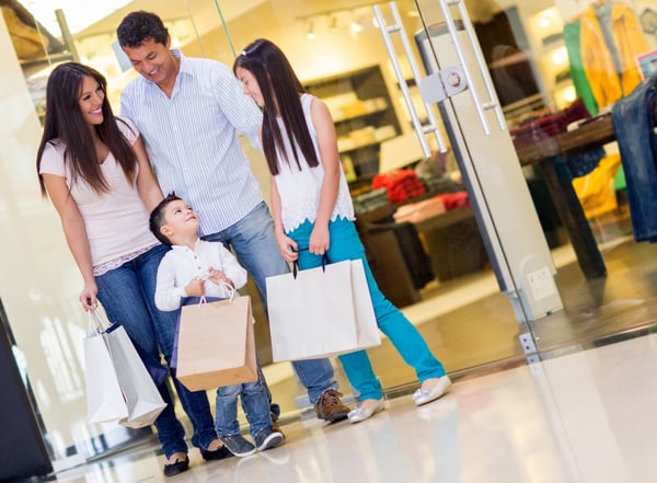 Happy family with shopping bags at the mall